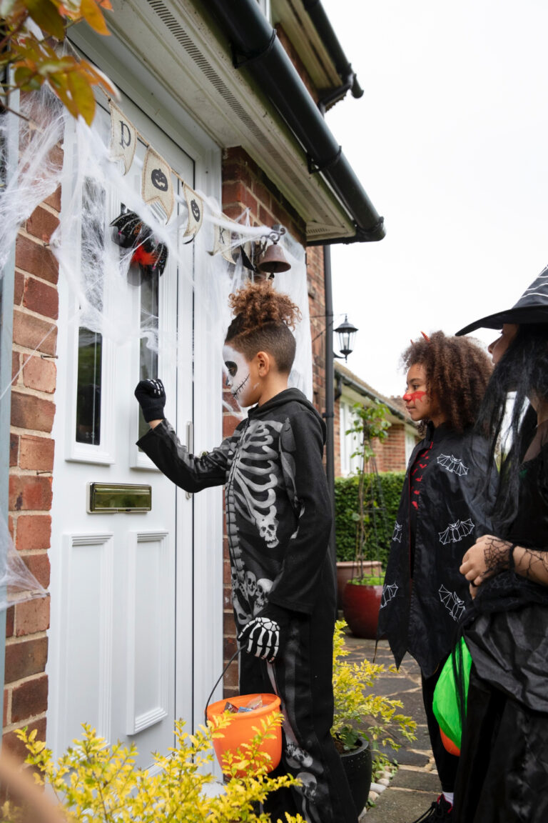 Trick-or-treaters outside modern new homes